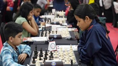 Photo of Local teen Maniar holds Grandmaster Mikulas to draw